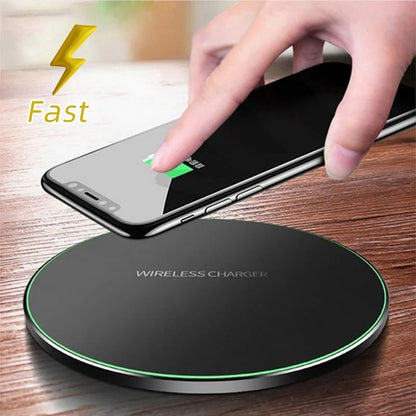 Hand placing a smartphone on a wireless charger.